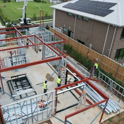 AAA project: Aerial view of construction site with workers assembling a steel framework